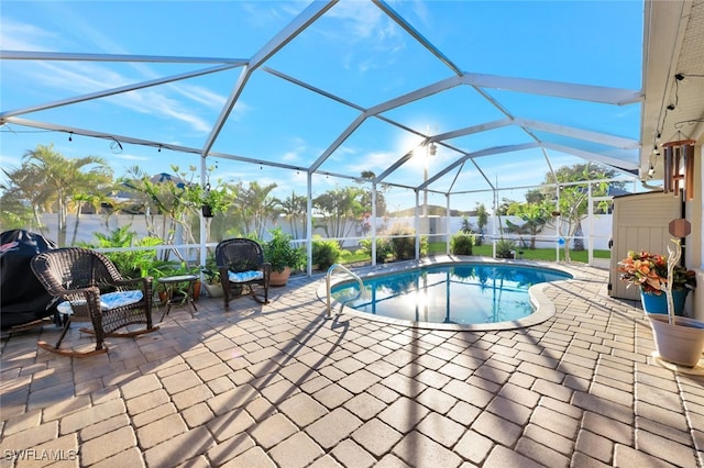 view of swimming pool with a lanai and a patio