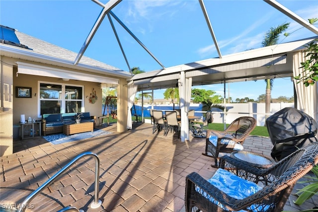 view of patio / terrace with glass enclosure and an outdoor living space