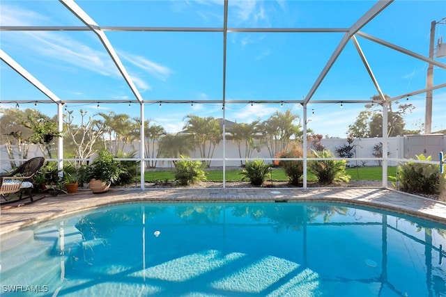 view of swimming pool featuring a lanai