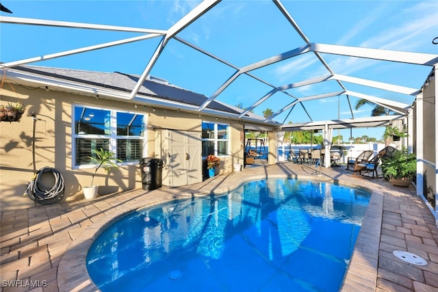 view of swimming pool with a lanai and a patio