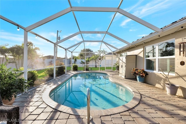 view of swimming pool featuring a lanai and a patio