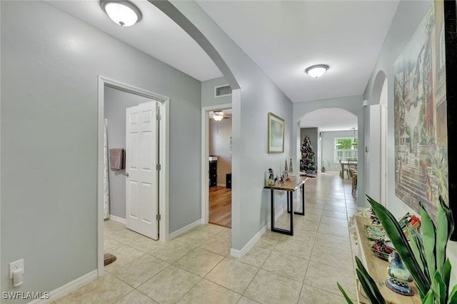 corridor with light tile patterned floors