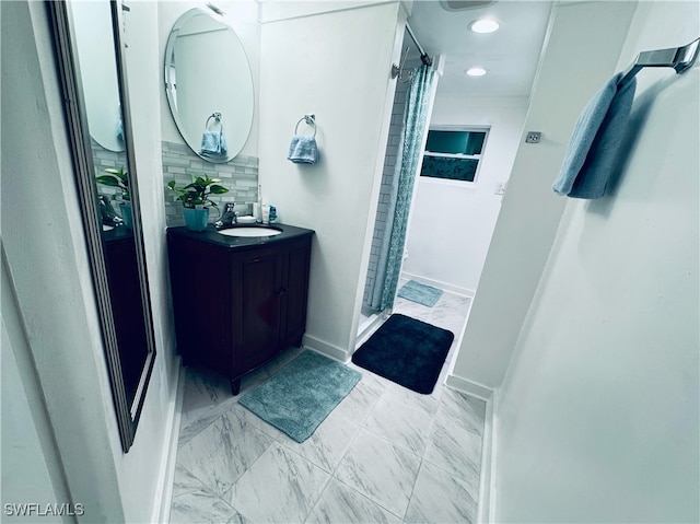 bathroom with vanity, walk in shower, and tasteful backsplash