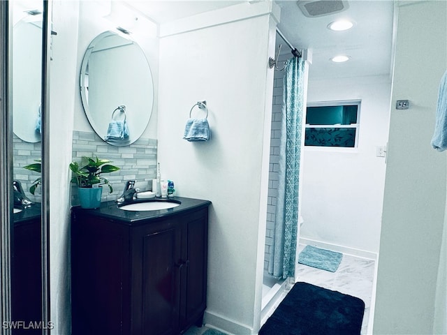 bathroom featuring backsplash, a shower with curtain, and vanity