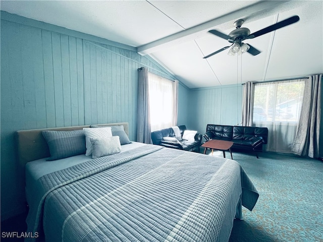 carpeted bedroom featuring vaulted ceiling with beams, multiple windows, and ceiling fan