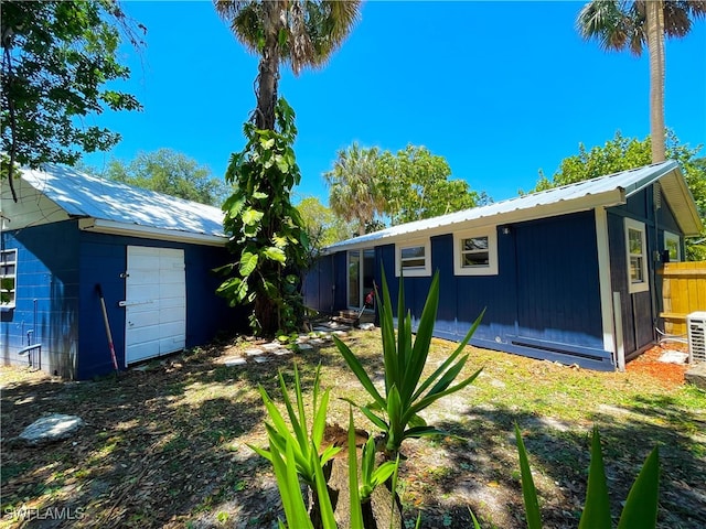 back of house featuring a garage