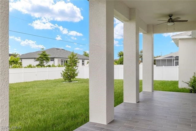 view of yard featuring ceiling fan and a patio area