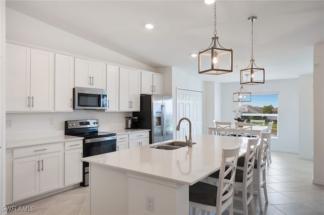 kitchen with sink, white cabinetry, a kitchen island with sink, stainless steel appliances, and decorative light fixtures