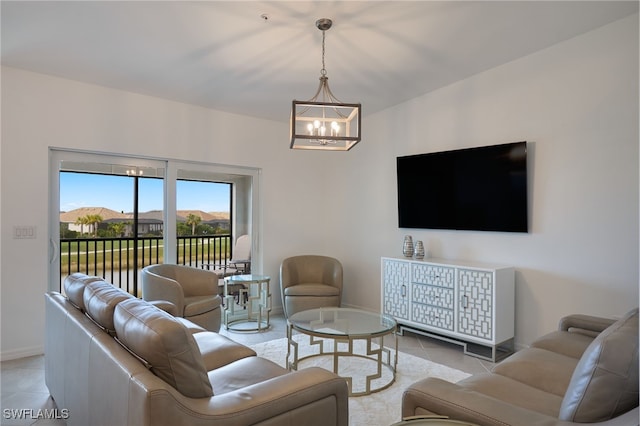 living room with a mountain view, light tile patterned floors, and an inviting chandelier