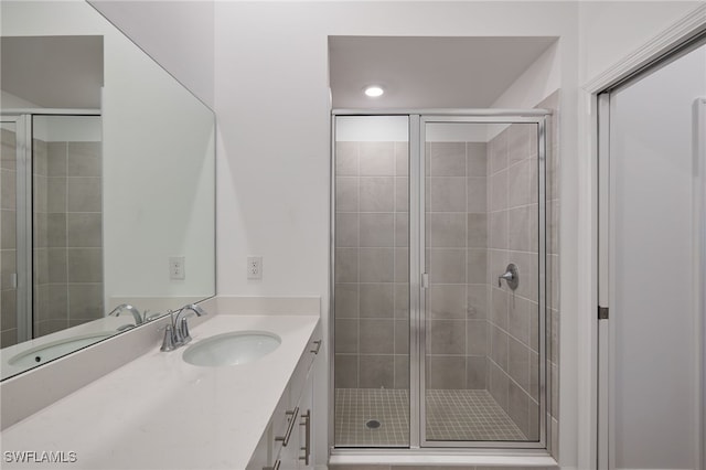 bathroom featuring vanity and a shower with shower door