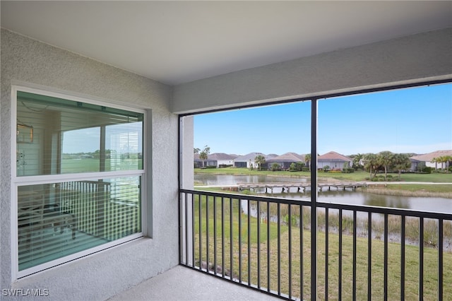 unfurnished sunroom with a water view