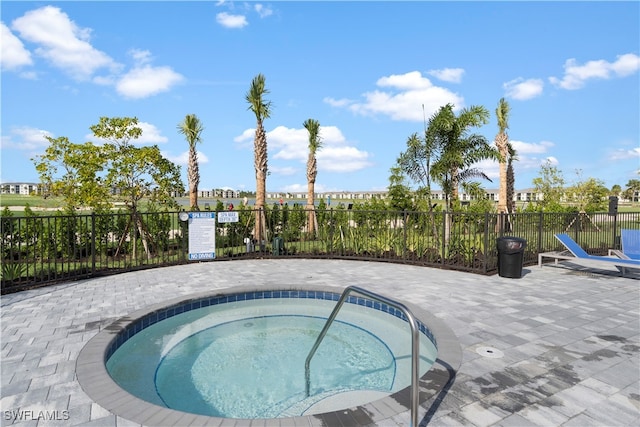 view of swimming pool with a patio area and a hot tub