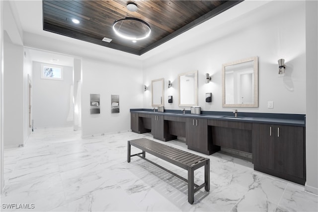 bathroom featuring vanity, wood ceiling, and a raised ceiling