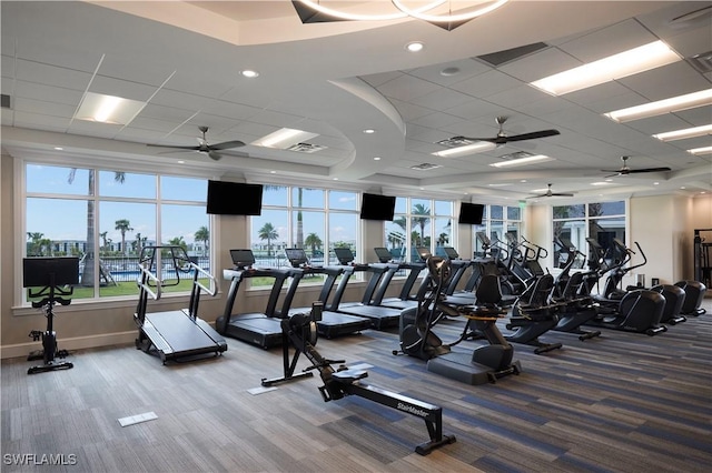 exercise room with a drop ceiling, a healthy amount of sunlight, and carpet