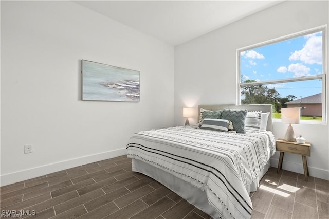 bedroom with dark hardwood / wood-style flooring