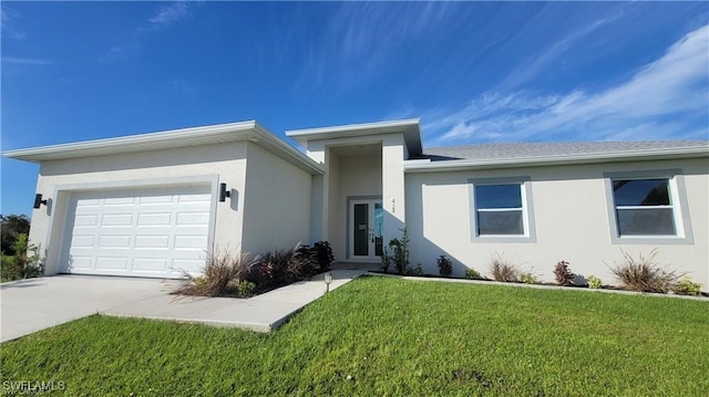 view of front of house with a front yard and a garage