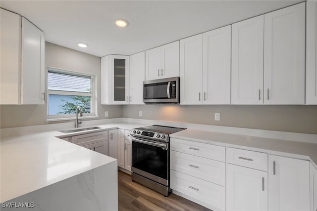 kitchen with sink, white cabinets, and appliances with stainless steel finishes