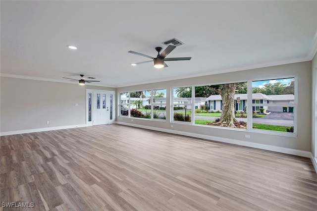 interior space with baseboards, visible vents, and crown molding