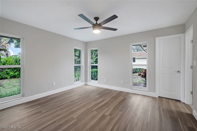 empty room with ceiling fan and hardwood / wood-style flooring