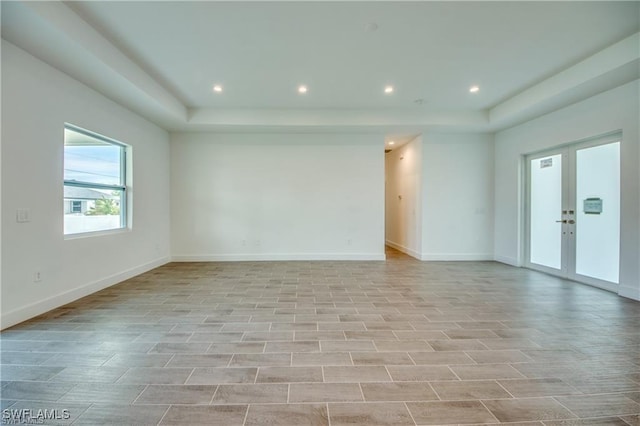 spare room with light hardwood / wood-style flooring and french doors