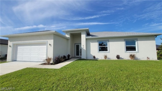 view of front of home with a garage and a front lawn