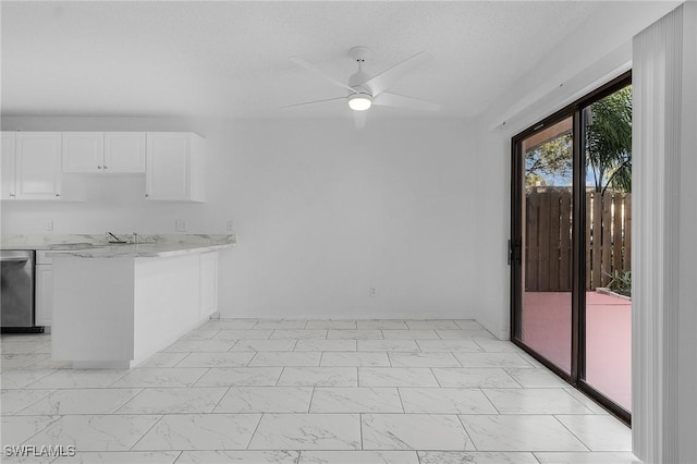 interior space with ceiling fan and a textured ceiling