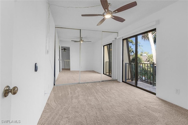 interior space featuring ceiling fan and light colored carpet