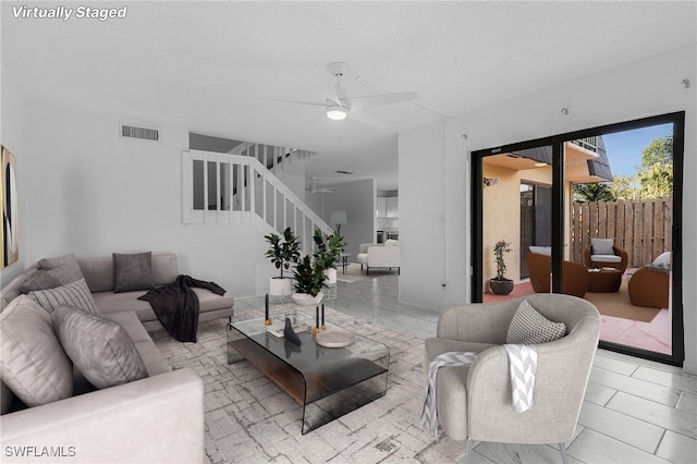 living room with ceiling fan and light tile patterned floors