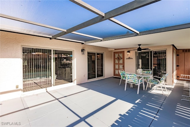 view of patio with ceiling fan and a lanai