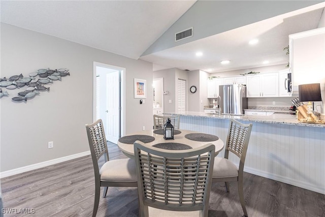 dining space with visible vents, baseboards, lofted ceiling, recessed lighting, and light wood-style floors