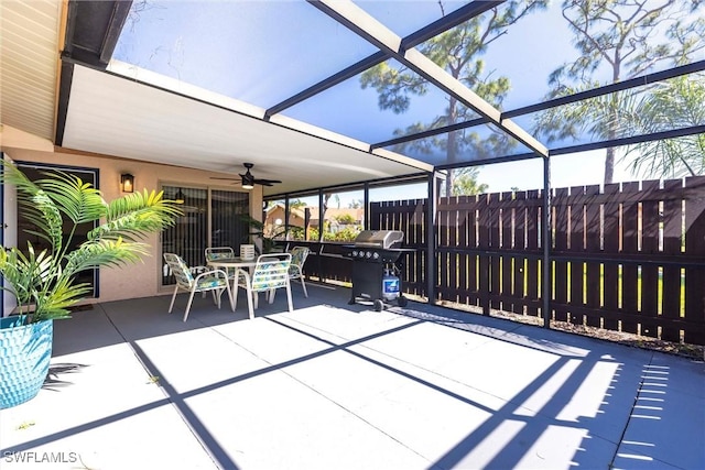 view of patio with outdoor dining area, area for grilling, a lanai, and fence