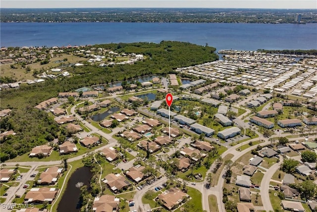 drone / aerial view with a water view and a residential view