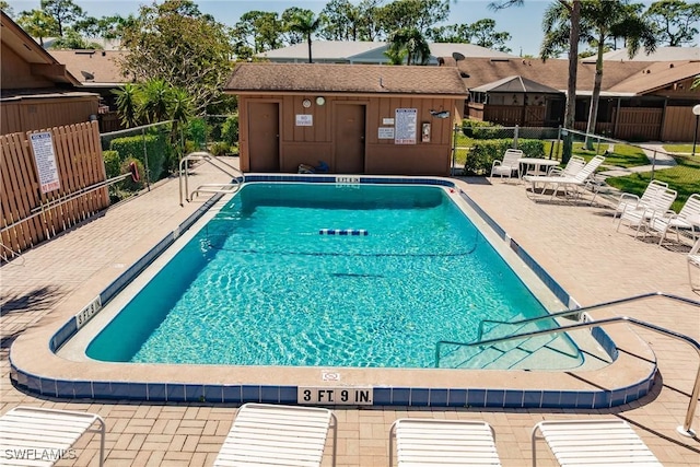 community pool featuring a patio area and fence