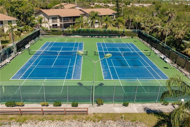 view of sport court featuring fence