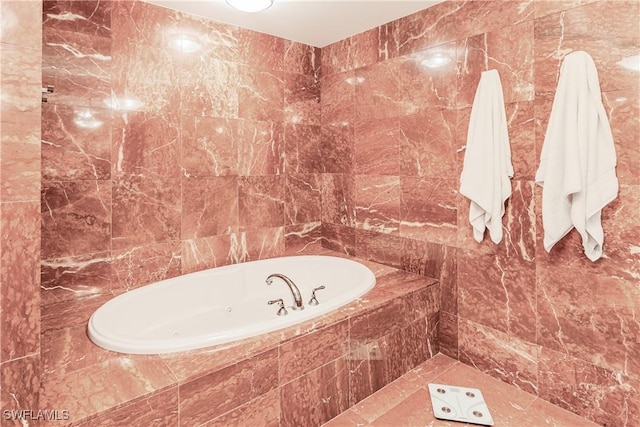 bathroom featuring tiled bath