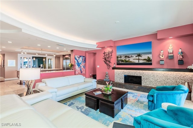 living room featuring a tiled fireplace