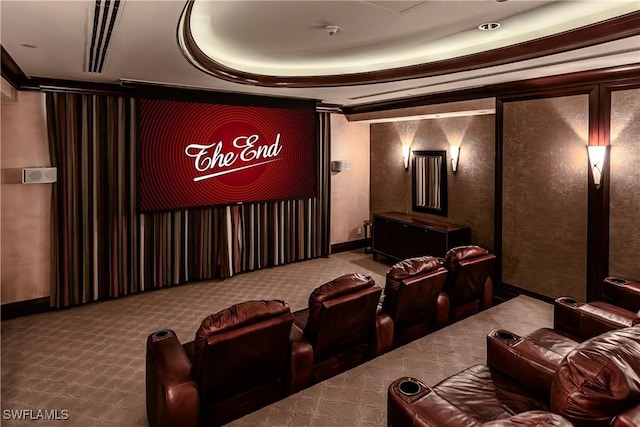 carpeted cinema room with a raised ceiling