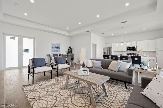 living room featuring french doors and light hardwood / wood-style flooring