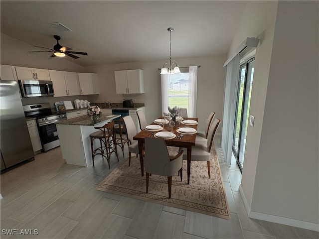 dining room with ceiling fan with notable chandelier