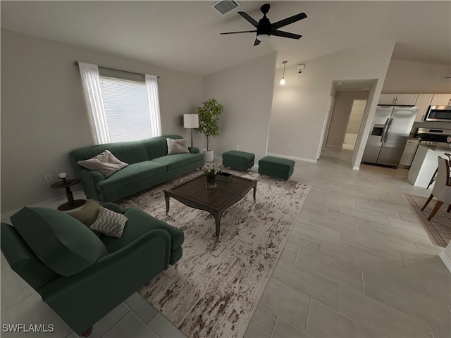 living room with light wood-type flooring, vaulted ceiling, and ceiling fan