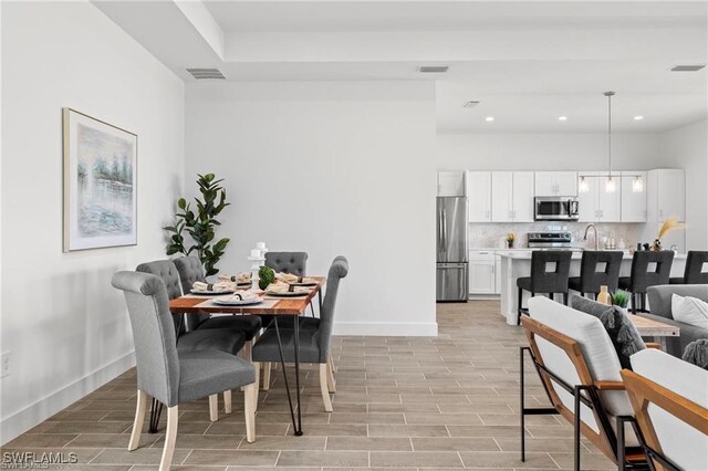 dining area featuring light wood-type flooring