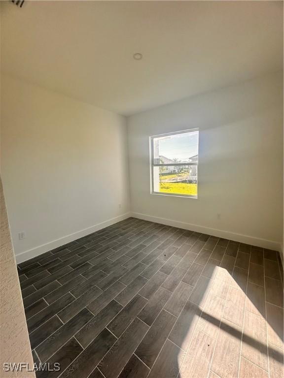 empty room featuring dark hardwood / wood-style floors