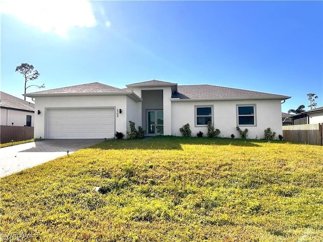 view of front of home featuring a front lawn and a garage