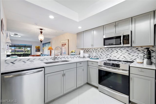 kitchen featuring a sink, stainless steel appliances, gray cabinets, and light countertops