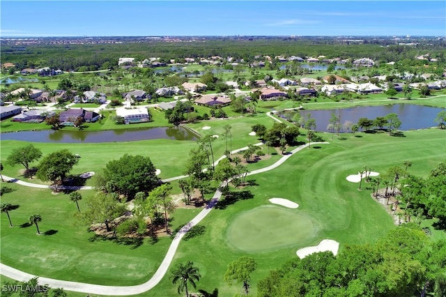 drone / aerial view with a water view, view of golf course, and a residential view