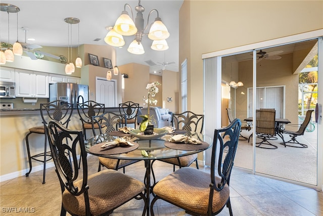 tiled dining room with high vaulted ceiling and ceiling fan with notable chandelier