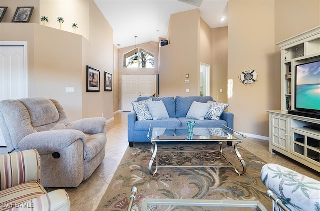 living room featuring high vaulted ceiling and light tile patterned floors