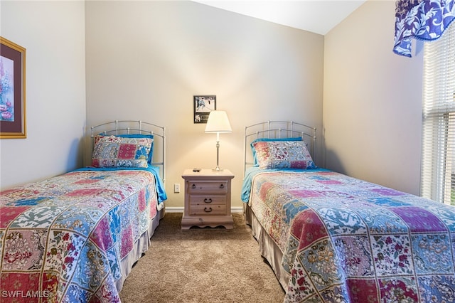 carpeted bedroom featuring lofted ceiling