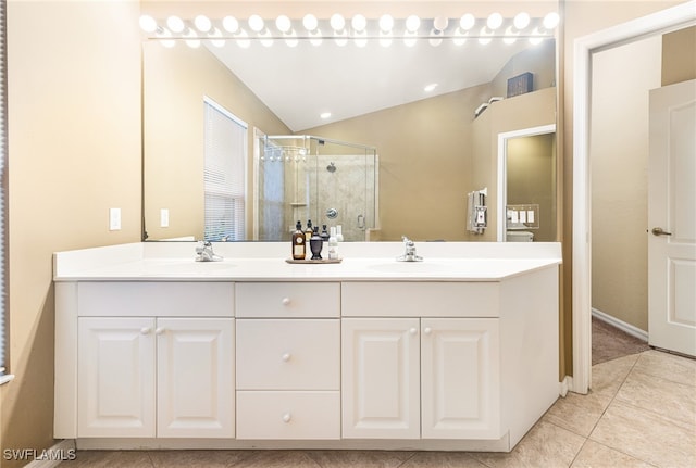 bathroom with tile patterned floors, vanity, an enclosed shower, and vaulted ceiling