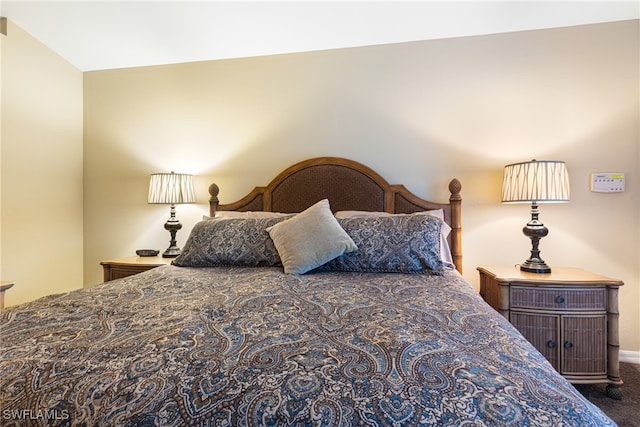 bedroom featuring dark carpet